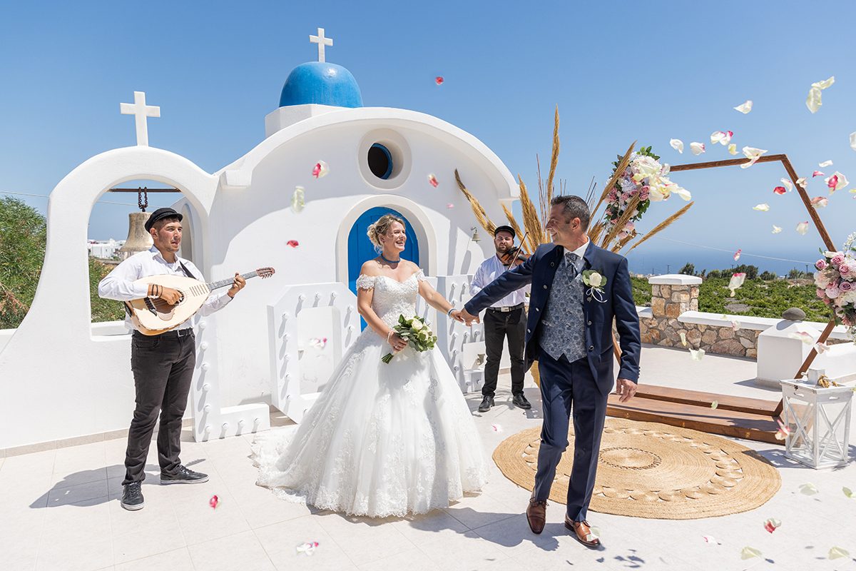 Ceremony at the blue-domed chapel with guests seated in the courtyard