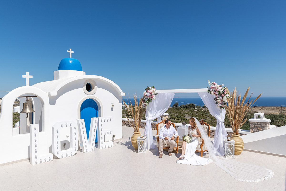 Blue-domed chapel dressed with a white ceremony arch