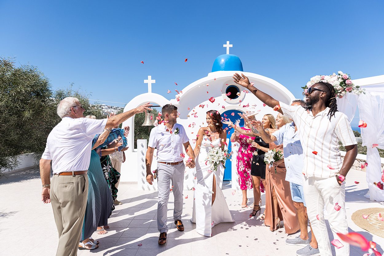 Confetti thrown over a couple leaving their Santorini ceremony