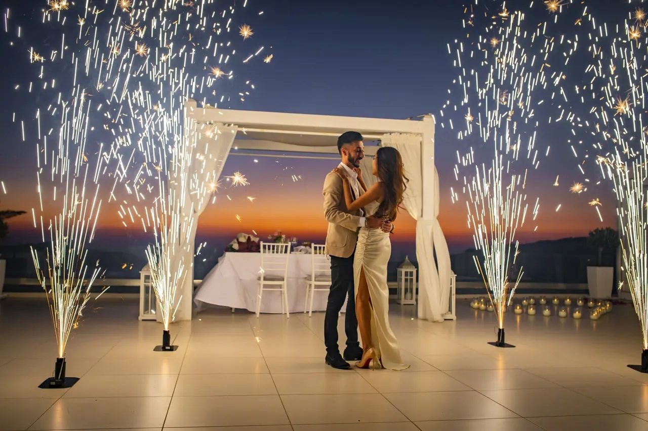 Fountain fireworks framing a couple at their evening ceremony