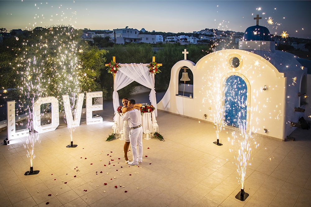 Blue-domed chapel lit at night with illuminated LOVE letters