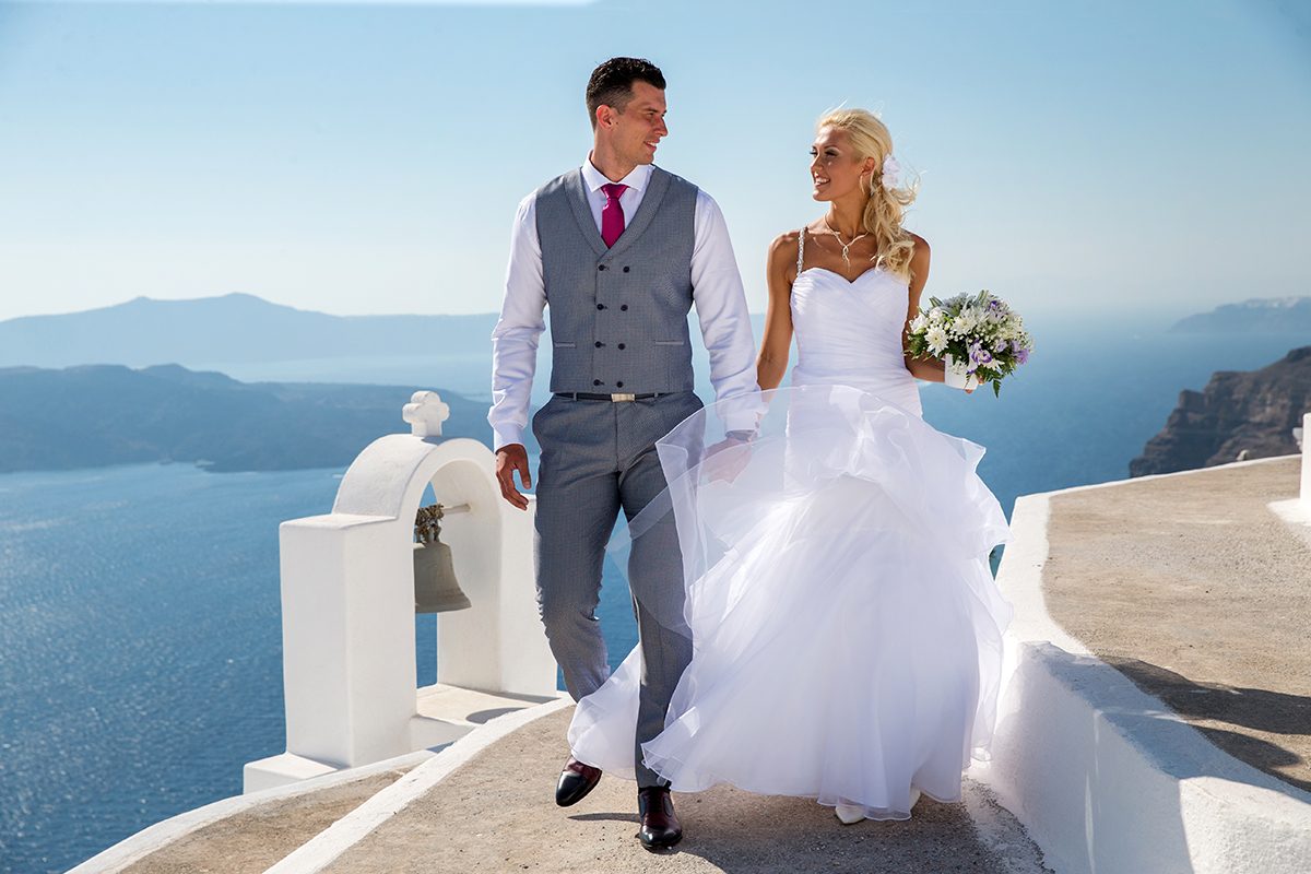 Couple photographed on whitewashed steps above the caldera