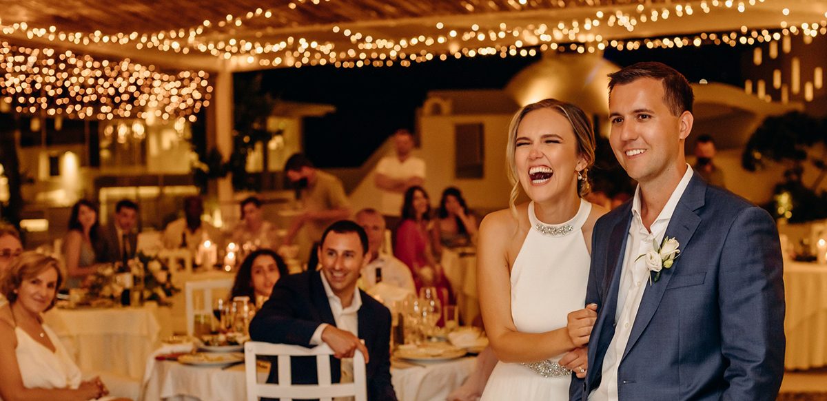 White draped ceremony arch set on the rocks