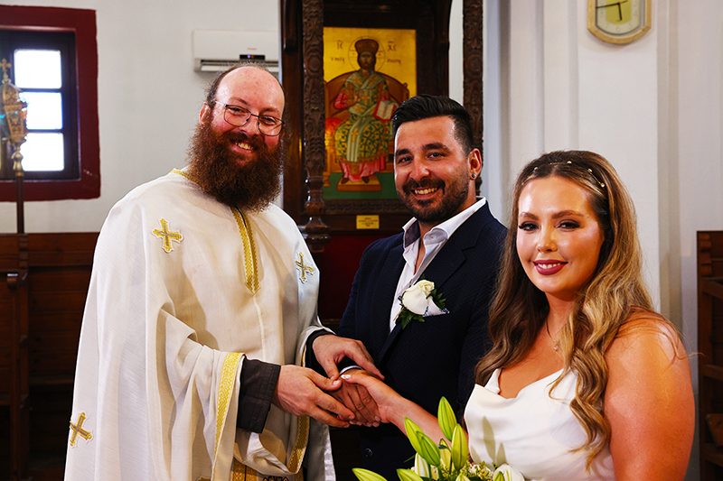 Father Leonidas conducting a Greek Orthodox wedding ceremony in Santorini