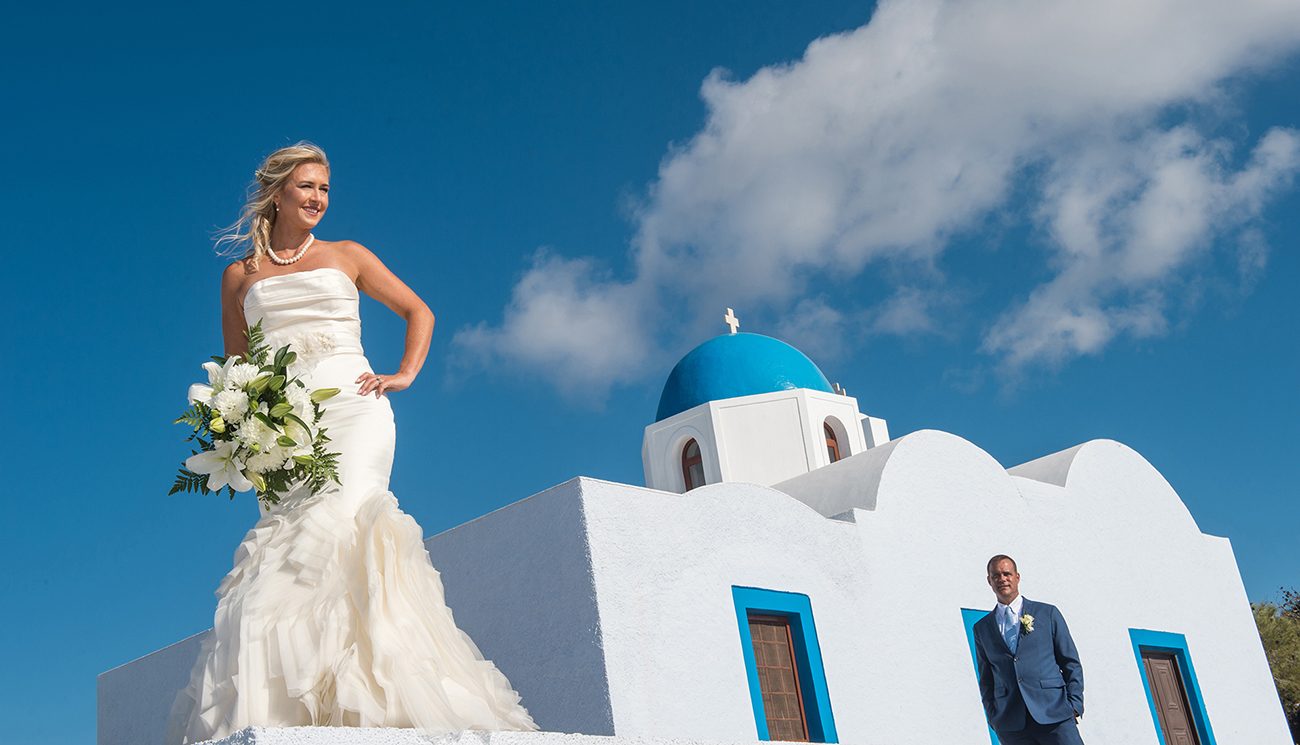 Bride with her bouquet at the blue-domed chapel
