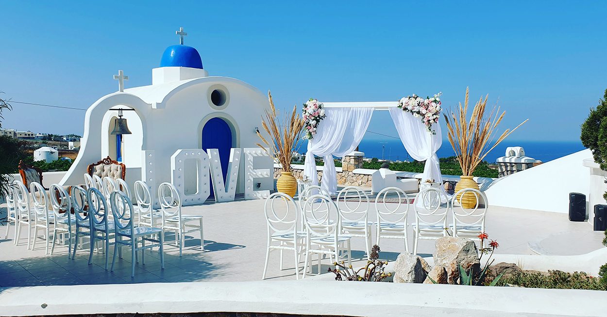 Blue-domed chapel venue set with white chairs