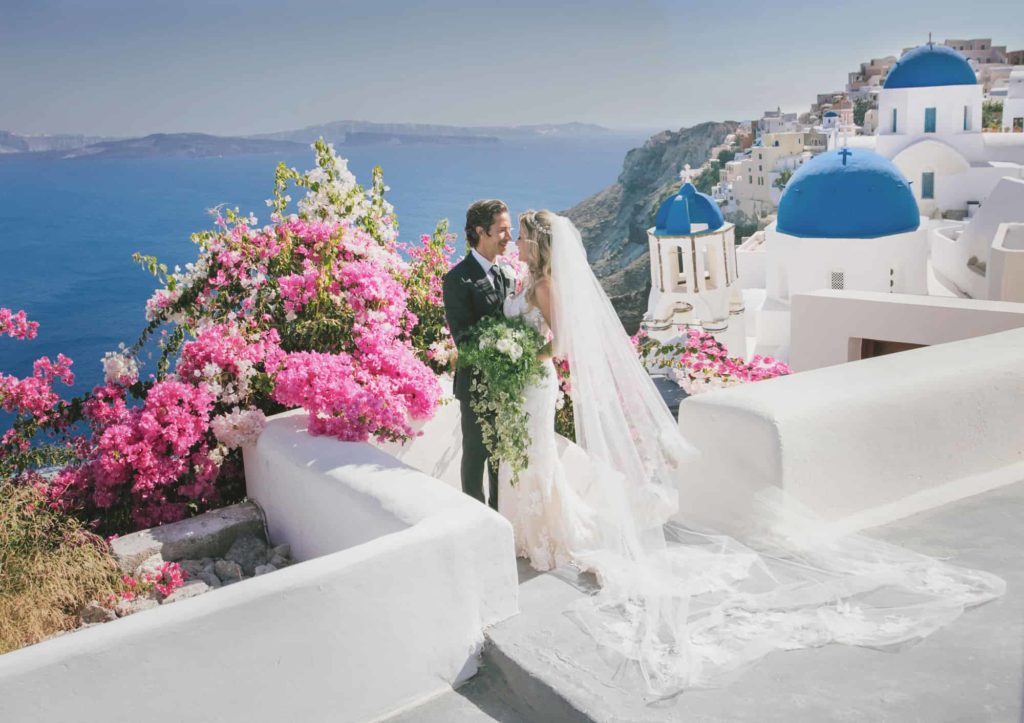 Wedding ceremony arch dressed in white above the Santorini caldera