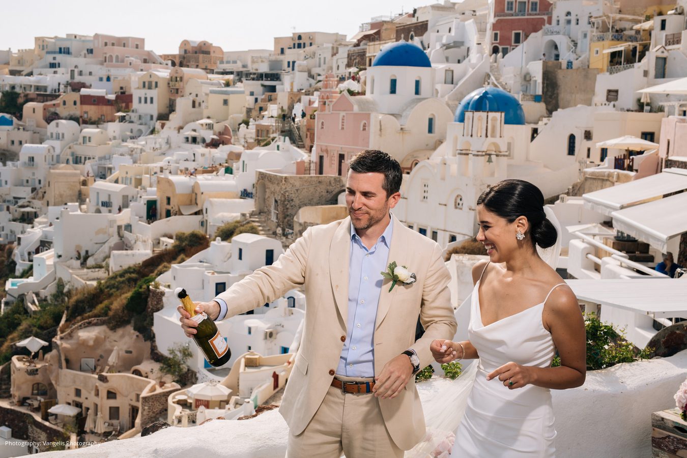 Wedding party celebrating outside a blue-domed chapel
